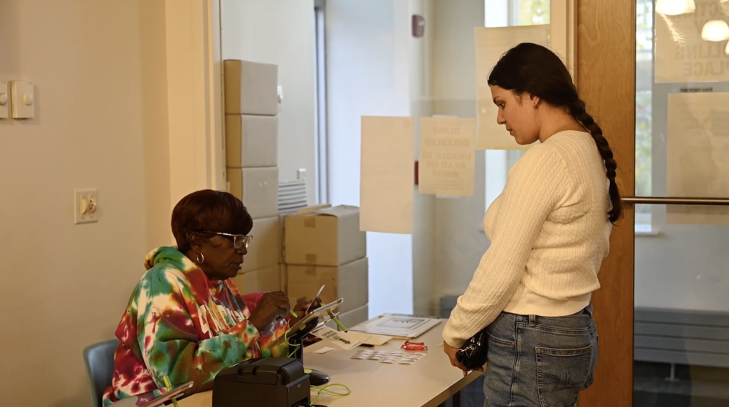 Isabella Rodriguez checks in at her polling site during the 2024 presidential election